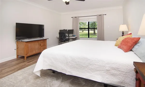 a bedroom with a bed and a television in it