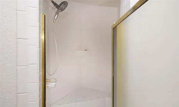 a bathroom with a glass shower door