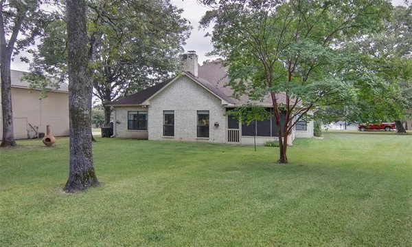 a view of a house with a yard and tree s