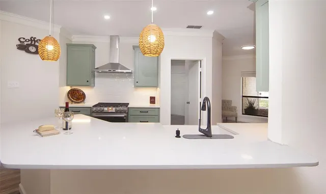 a view of kitchen and living room with wooden floor
