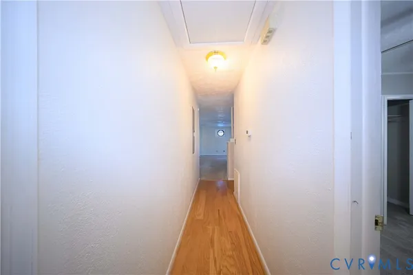 a view of a bathroom from a corridor