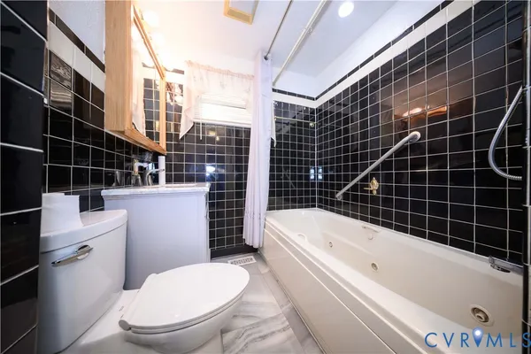 a white toilet sitting next to a bathroom sink
