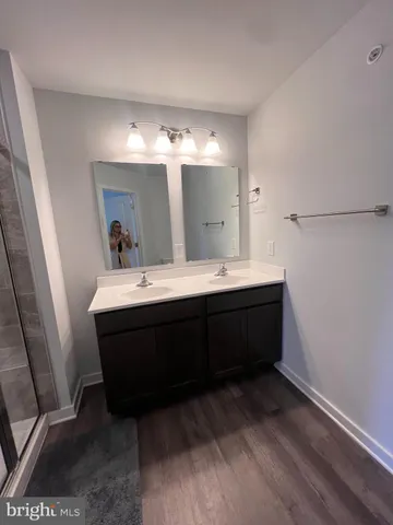 a bathroom with a double vanity sink and a mirror