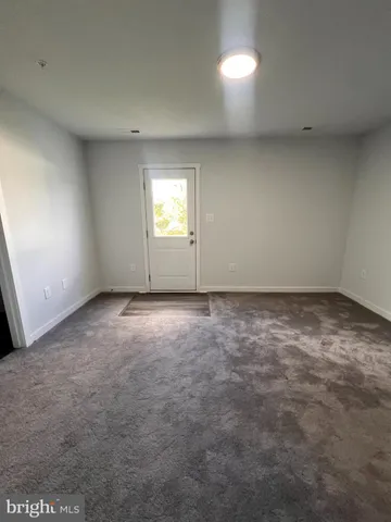 an empty room with a empty space and windows