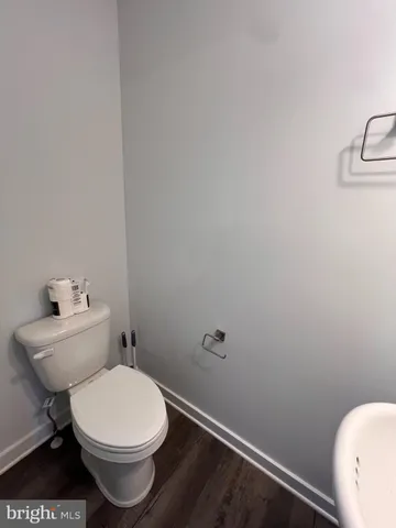 a white toilet sitting next to a white sink