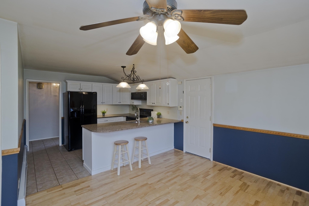 151 Bemis Road Holyoke, MA 01040 - Photo 11 of 42 a kitchen with kitchen island stainless steel appliances sink cabinets and wooden floor