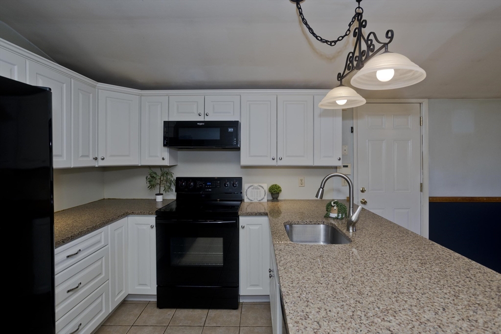 151 Bemis Road Holyoke, MA 01040 - Photo 16 of 42 a kitchen with a sink and cabinets