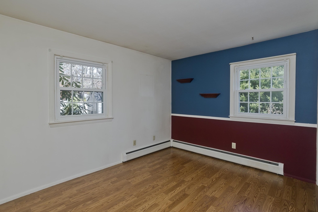 151 Bemis Road Holyoke, MA 01040 - Photo 28 of 42 an empty room with wooden floor and windows