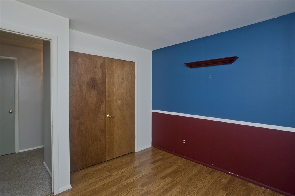 151 Bemis Road Holyoke, MA 01040 - Photo 34 of 42 an empty room with wooden floor and windows