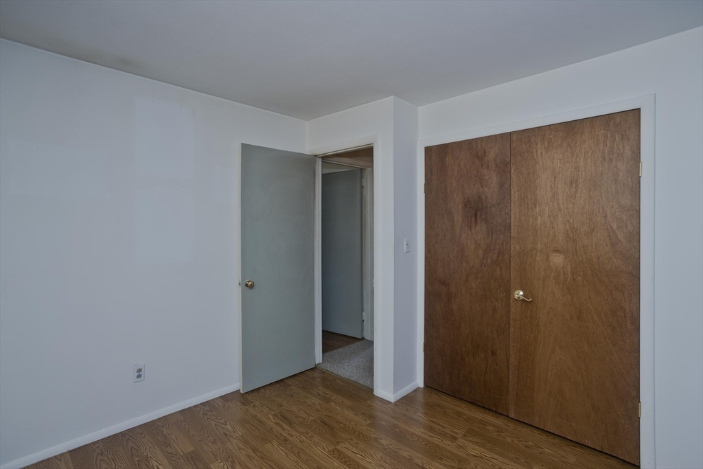 151 Bemis Road Holyoke, MA 01040 - Photo 35 of 42 a view of an empty room with wooden floor and closet area