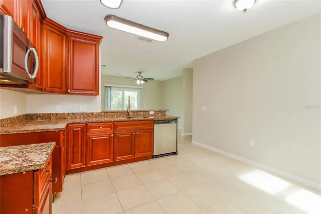 a spacious bathroom with a granite countertop sink and a mirror