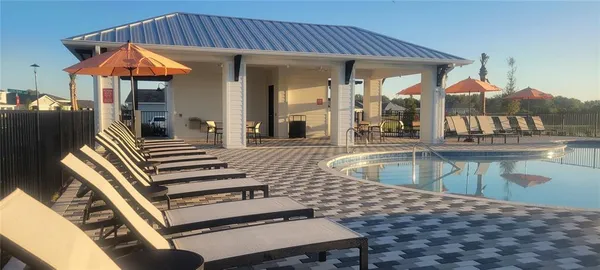 a view of a patio with swimming pool table and chairs