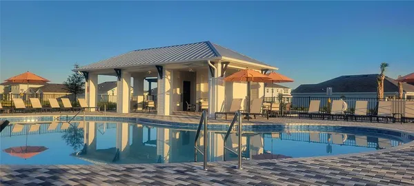a view of a house with pool and windows