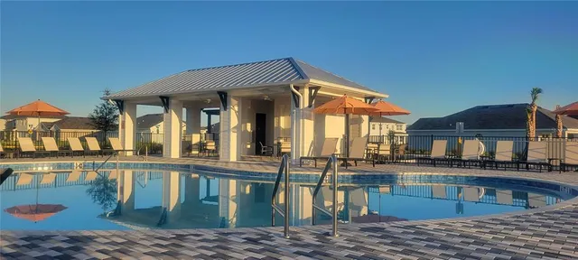 a view of a house with pool and windows
