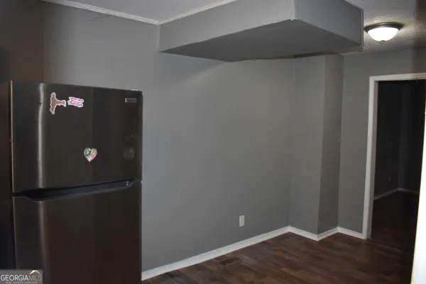 an empty room with wooden floor and closet