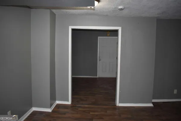a view of hallway with wooden floor