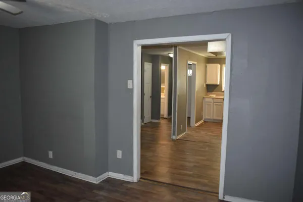 a view of a hallway with wooden floor