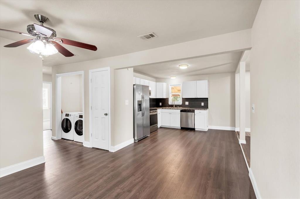1309 Pine Street Bonham, TX 75418 - Photo 13 of 33 a view of kitchen with refrigerator microwave and wooden floor