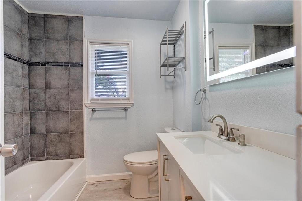 1309 Pine Street Bonham, TX 75418 - Photo 17 of 33 a bathroom with a sink toilet and shower