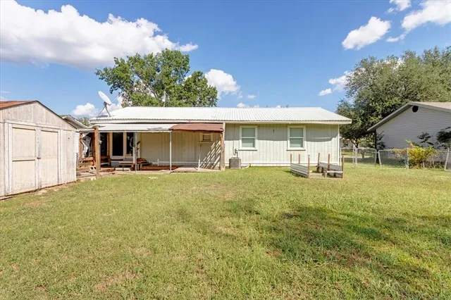 a view of a house with a backyard