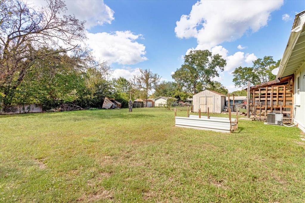 1309 Pine Street Bonham, TX 75418 - Photo 26 of 33 a view of a swimming pool with an outdoor seating and a yard