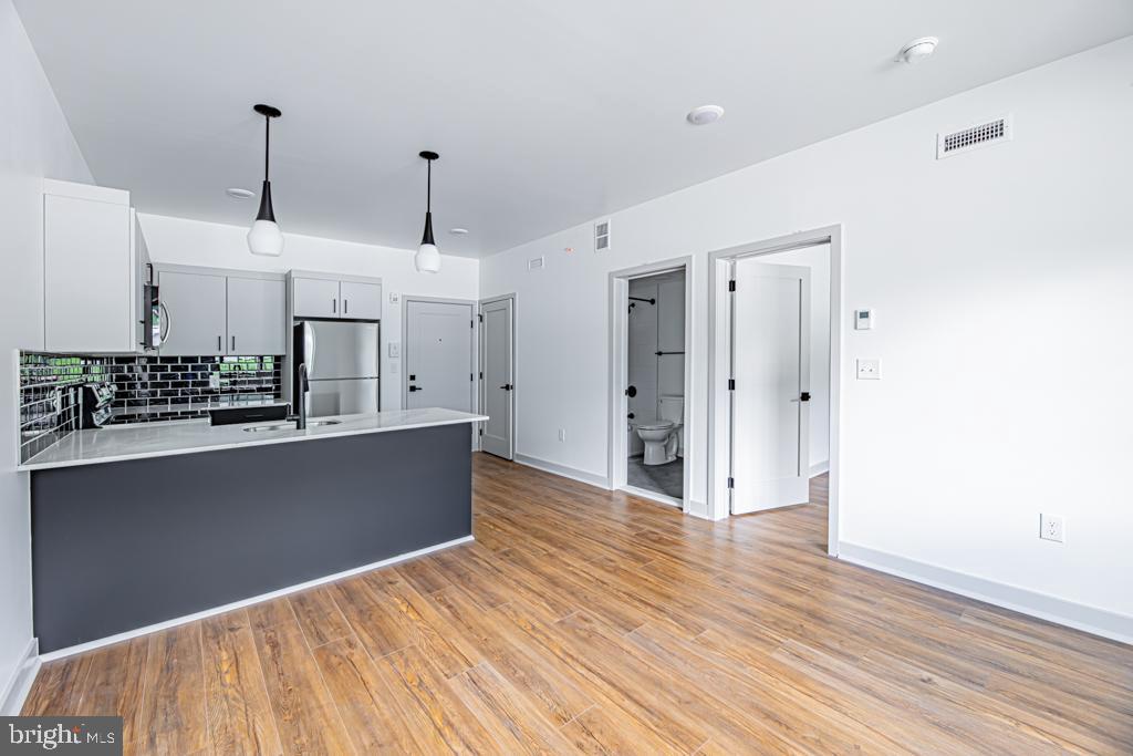 5001 Umbria Street, Unit U400 Philadelphia, PA 19128 - Photo 5 of 11 a view of kitchen with stainless steel appliances refrigerator stove microwave and cabinets