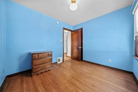 a view of room with wooden floor and window