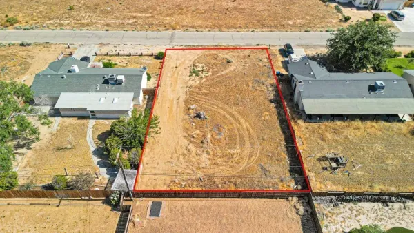an aerial view of residential houses with outdoor space and ocean view