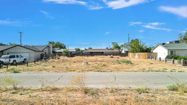 a view of a road with a house in the background
