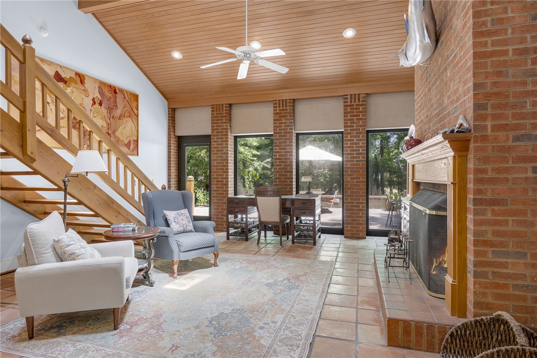 218 Northridge Drive Anderson, SC 29621 - Photo 16 of 50 A well-lit interior features a prominent brick fireplace and rich wood ceiling, creating a warm, inviting atmosphere.