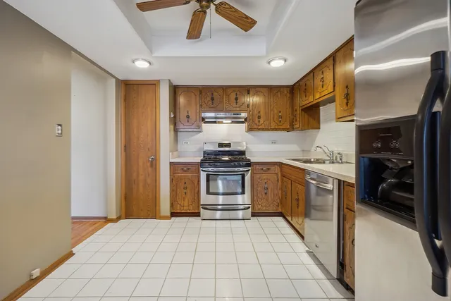 a kitchen with stainless steel appliances granite countertop a stove and a refrigerator