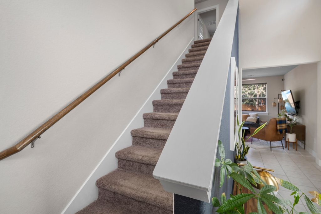 610 Bernstein Street, Unit 14 Austin, TX 78745 - Photo 16 of 39 Staircase with tile patterned flooring and baseboards