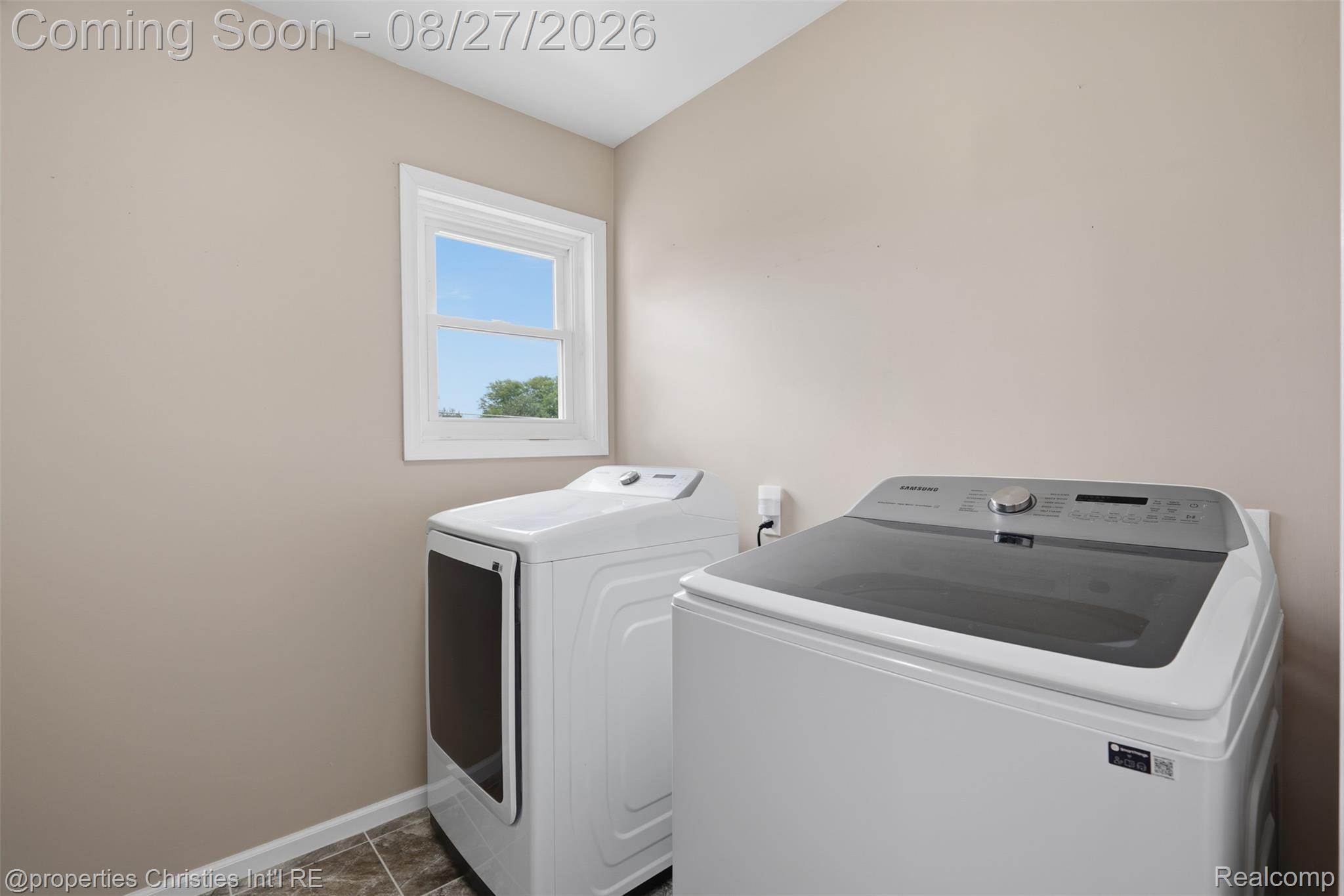 8104 Flintlock Road Mount Morris, MI 48458 - Photo 21 of 42 Laundry area featuring a large window with cabinetry and counterspace
