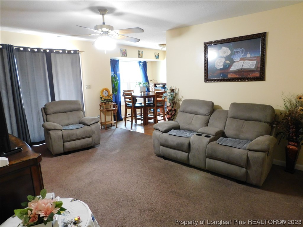 215 Duncan Road Spring Lake, NC 28390 - Photo 11 of 19 a living room with furniture and a chandelier