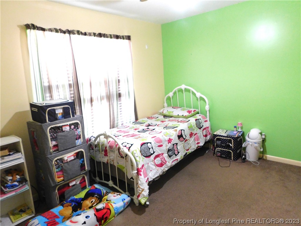 215 Duncan Road Spring Lake, NC 28390 - Photo 13 of 19 a bedroom with a bed and a window