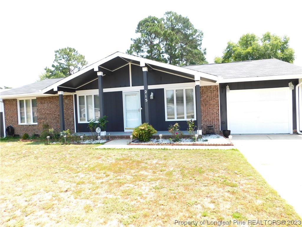 215 Duncan Road Spring Lake, NC 28390 - Photo 2 of 19 a view of a house with swimming pool and sitting area