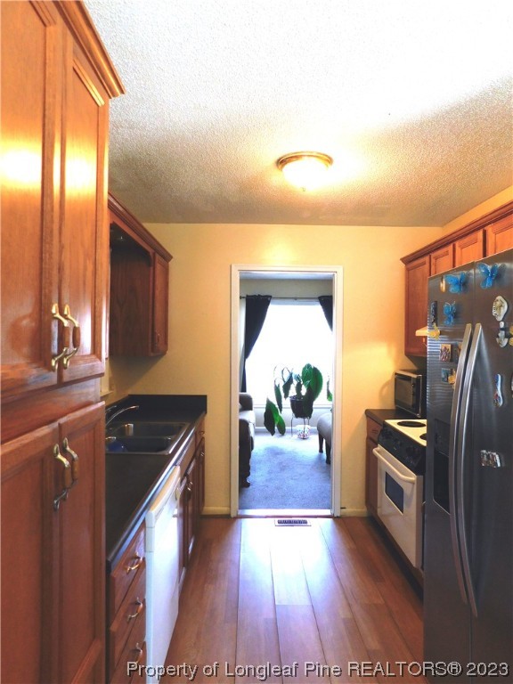 215 Duncan Road Spring Lake, NC 28390 - Photo 6 of 19 a kitchen with stainless steel appliances granite countertop a sink stove and refrigerator