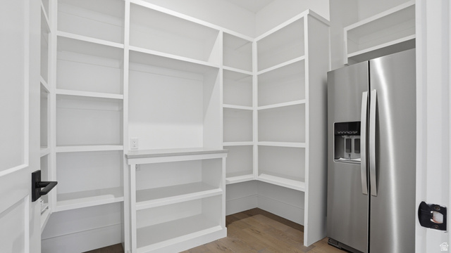1682 North 1950 W Street, Unit 9 Provo, UT 84604 - Photo 22 of 84 Walk-in pantry featuring extensive built-in shelving, a built-in counter, and wood-finish flooring