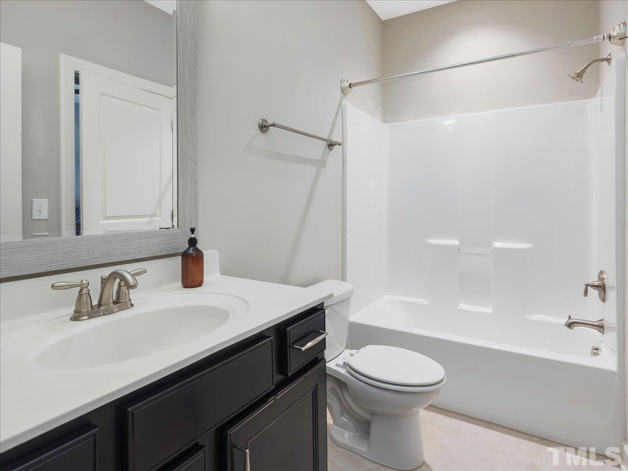 604 Chapanoke Road Raleigh, NC 27603 - Photo 24 of 30 a bathroom with a sink a toilet and a bathtub