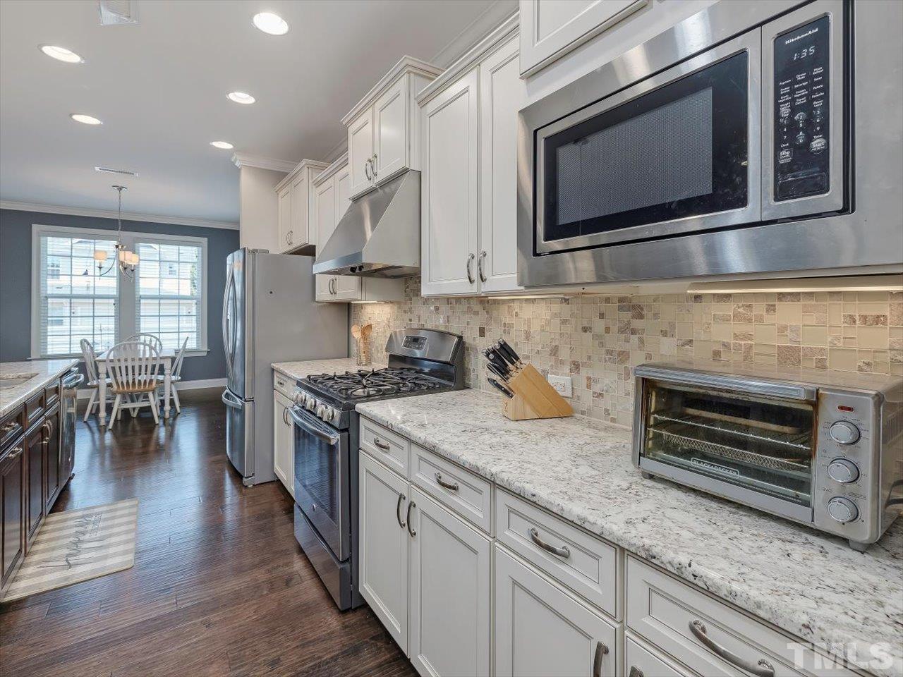 604 Chapanoke Road Raleigh, NC 27603 - Photo 3 of 30 a kitchen with stainless steel appliances granite countertop a stove microwave and cabinets