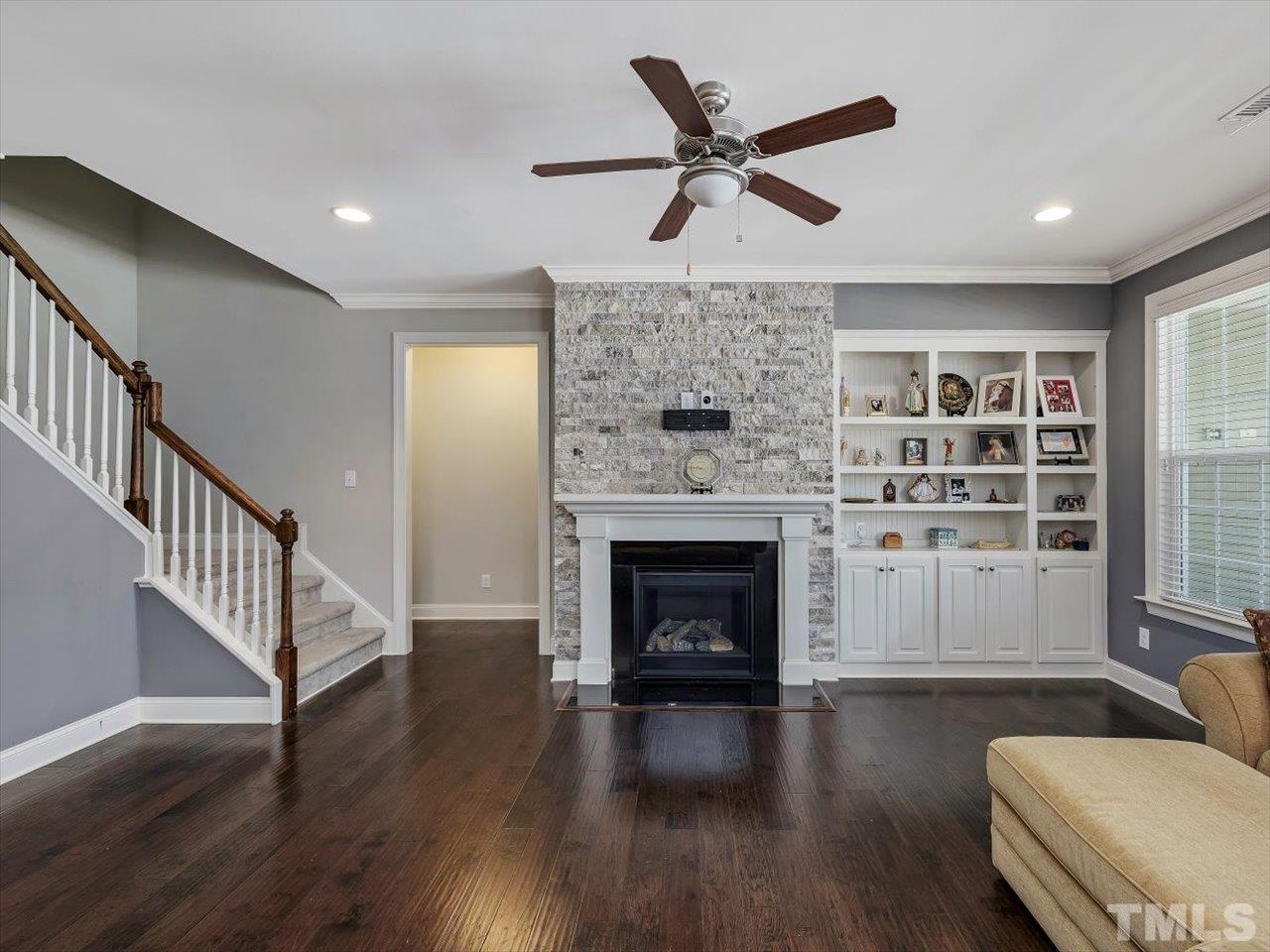 604 Chapanoke Road Raleigh, NC 27603 - Photo 7 of 30 a living room with furniture and a fireplace