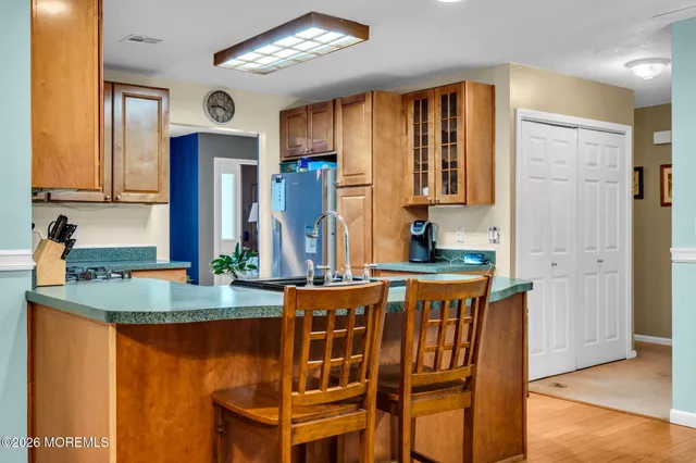 a dining table with chairs and cabinets