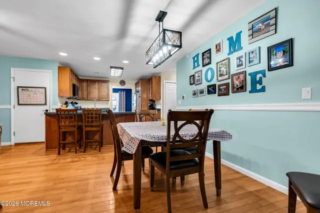 a view of a dining room with furniture and a kitchen