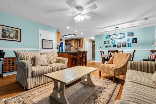 a living room with furniture a rug and a chandelier