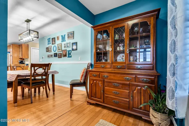 a view of a dining room with furniture and chandelier