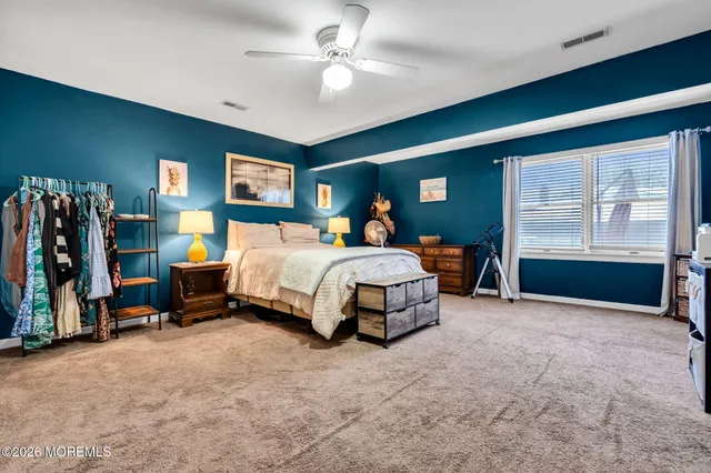 a bedroom with a bed and ceiling fan