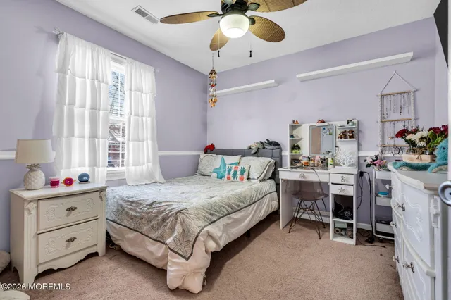 a bedroom with a bed closet and a window