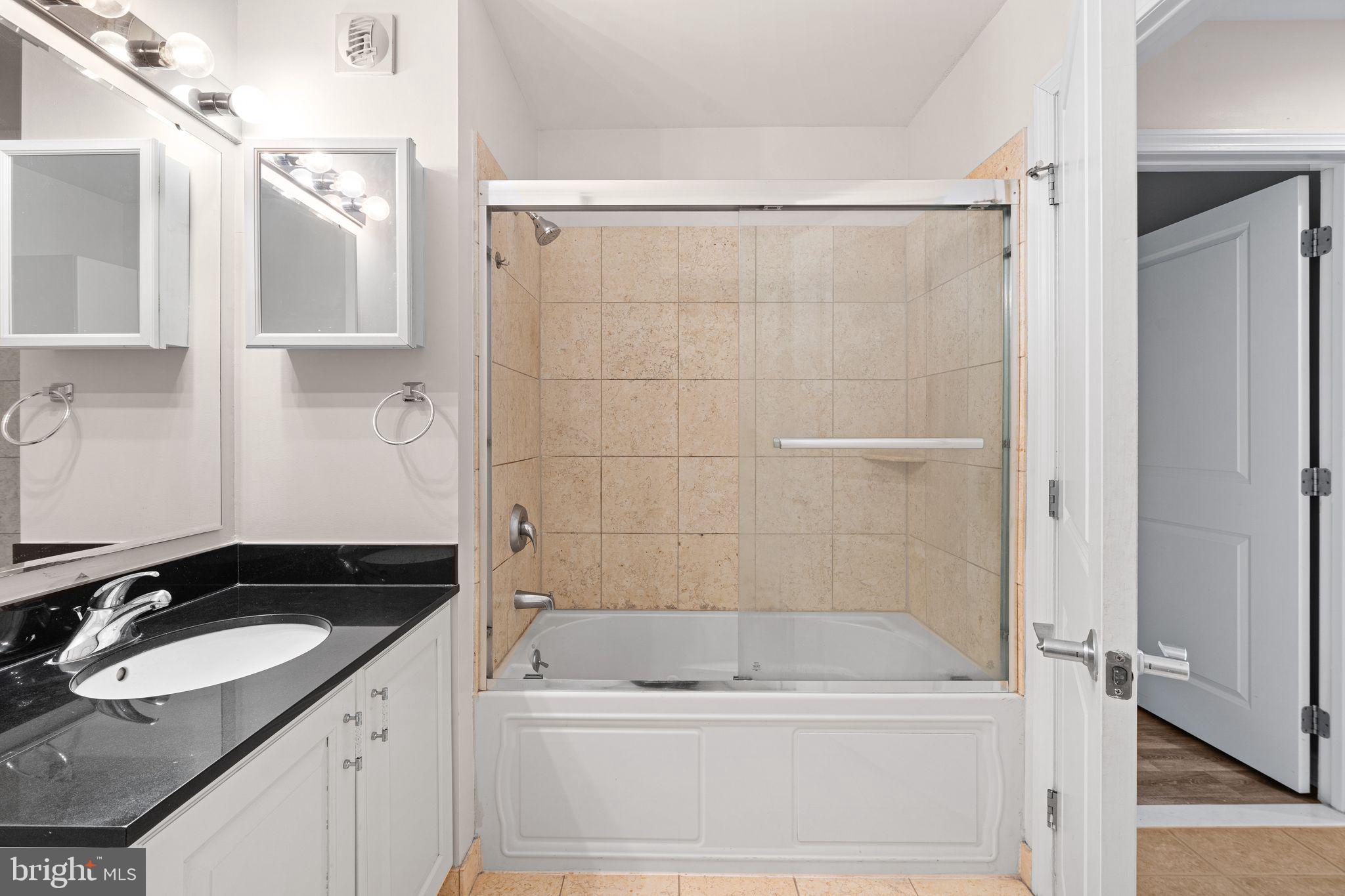 901 North Penn Street, Unit R506 Philadelphia, PA 19123 - Photo 10 of 10 a bathroom with a granite countertop sink a toilet and shower
