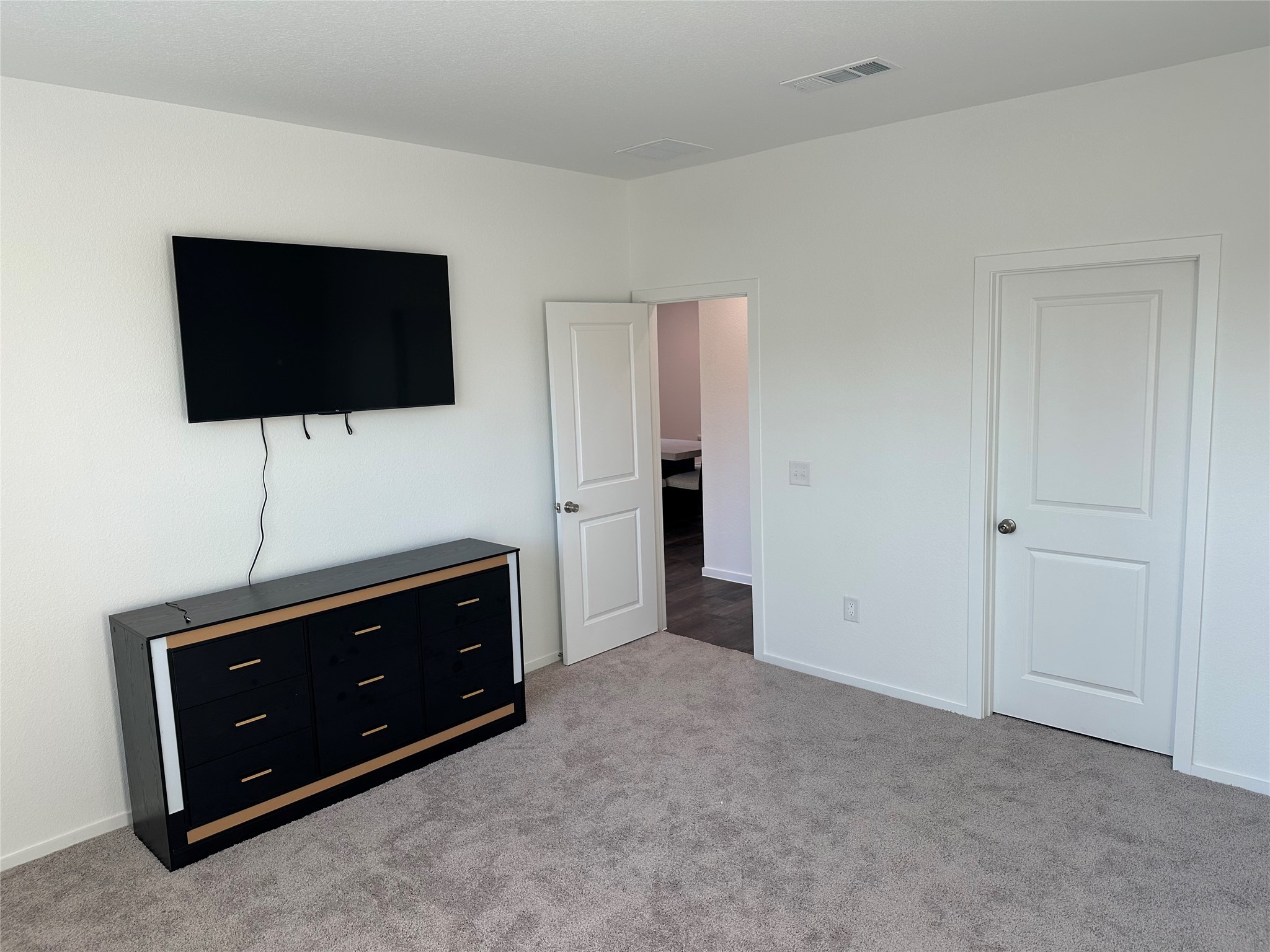 16936 Juniper Blossom Bend Conroe, TX 77302 - Photo 13 of 28 a living room with flat screen tv and floor to ceiling window