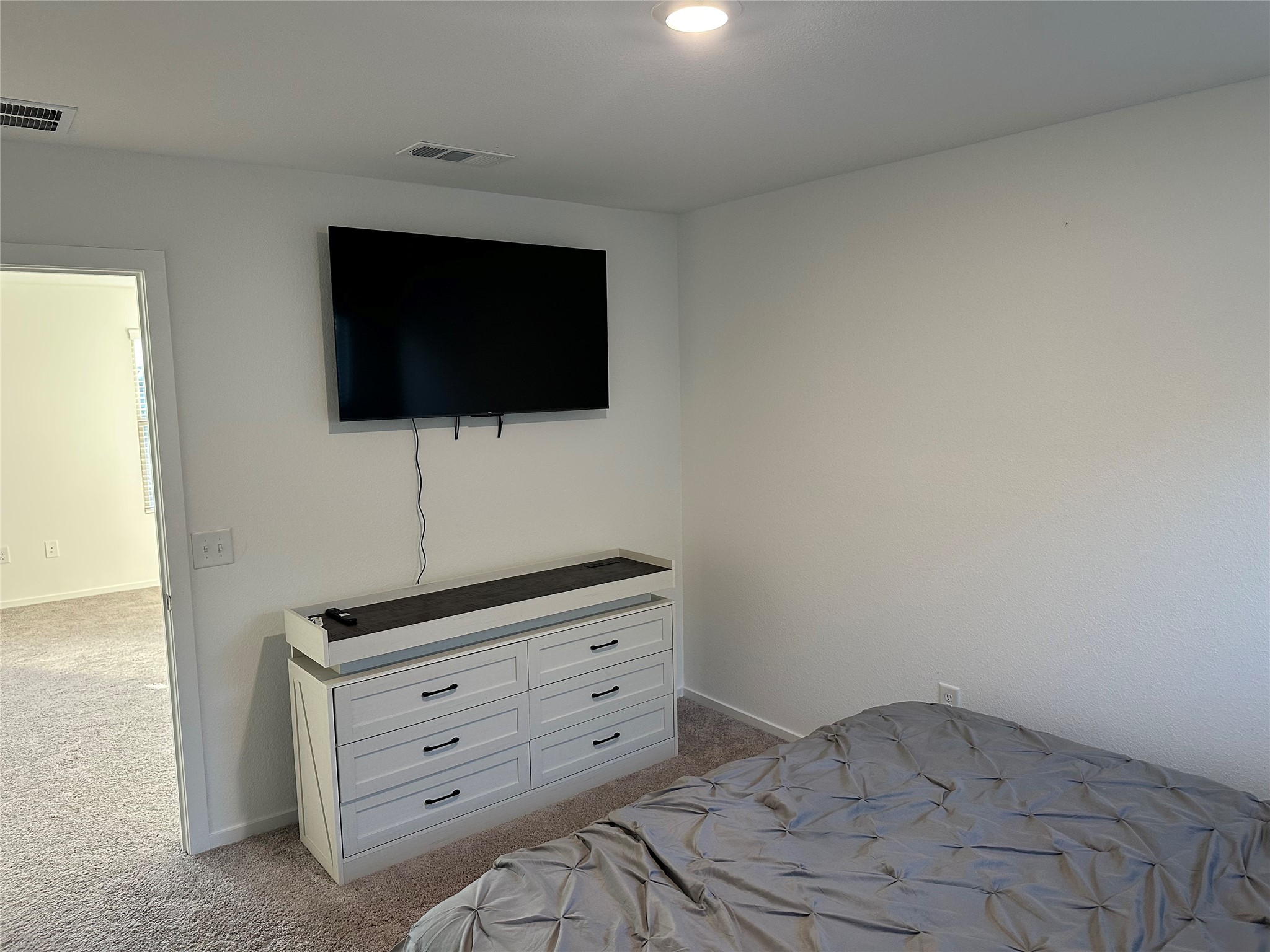 16936 Juniper Blossom Bend Conroe, TX 77302 - Photo 20 of 28 a room with a flat screen tv and dresser